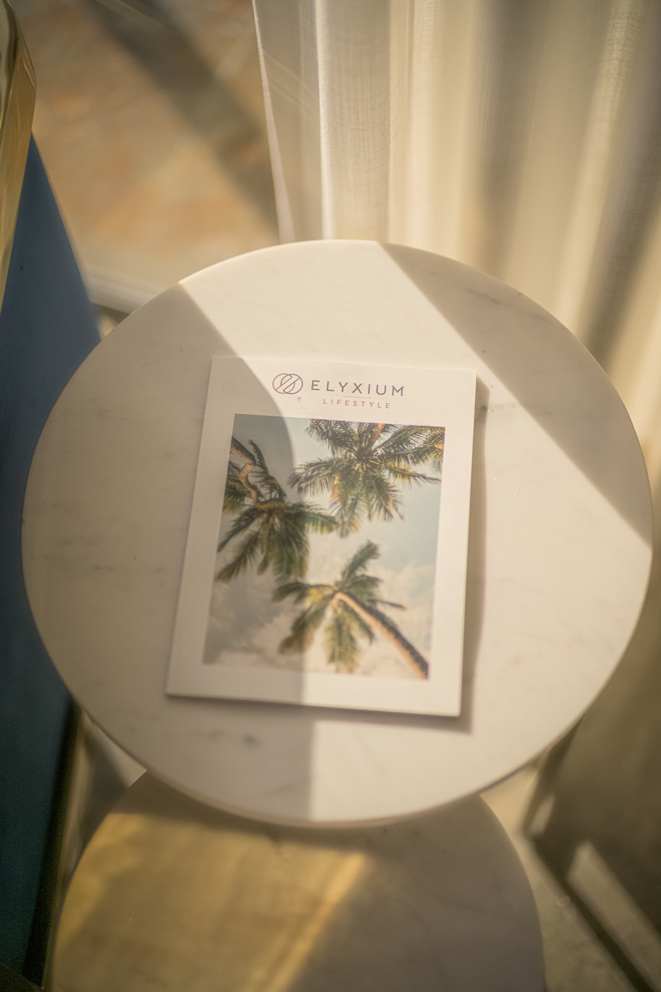 Elyxium Lifestyle booklet in warm afternoon sunlight